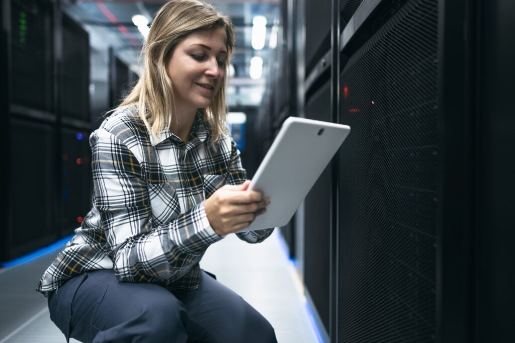 woman in a data center working with servers